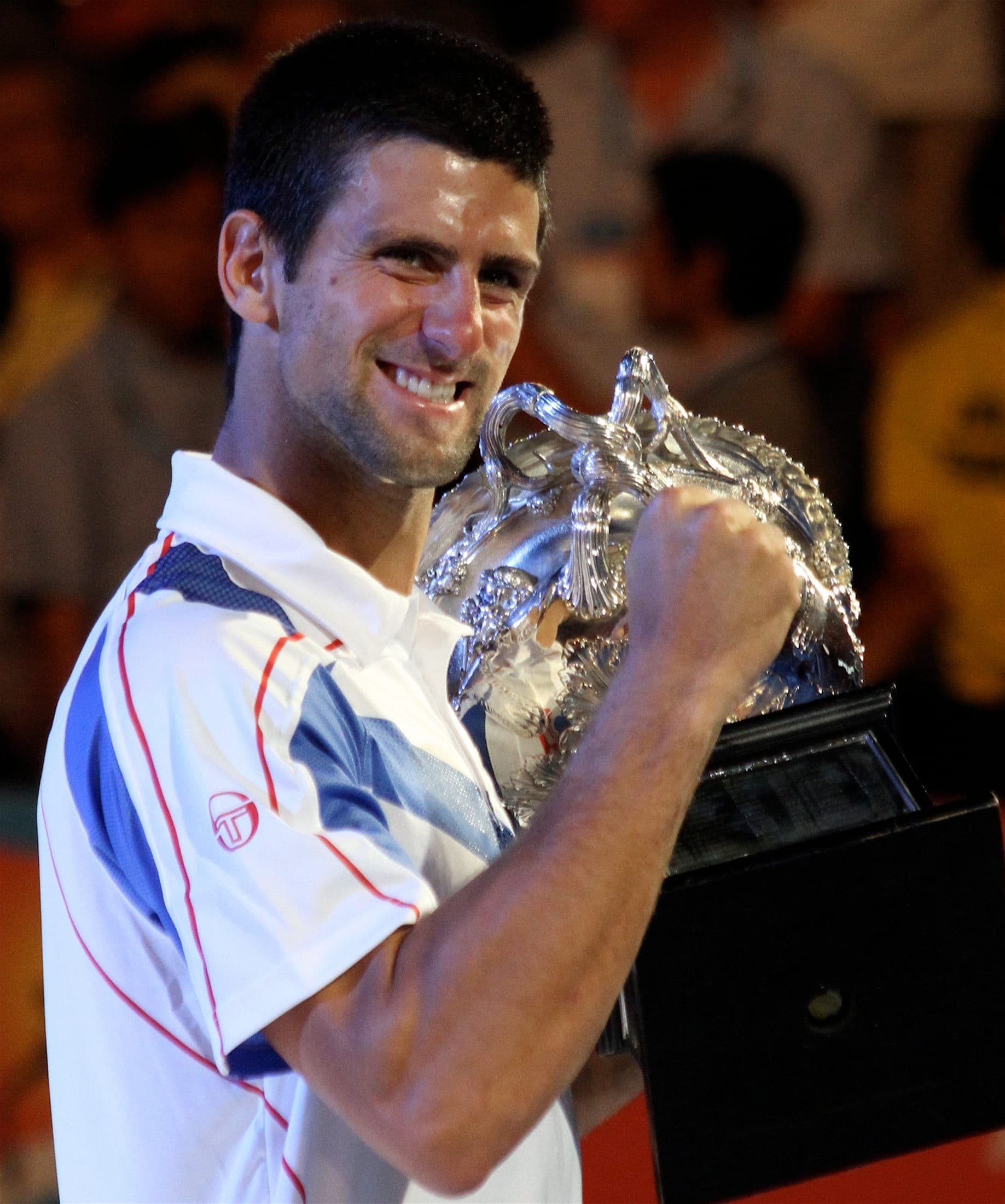 Novak Djokovic celebrating with the Australian Open trophy