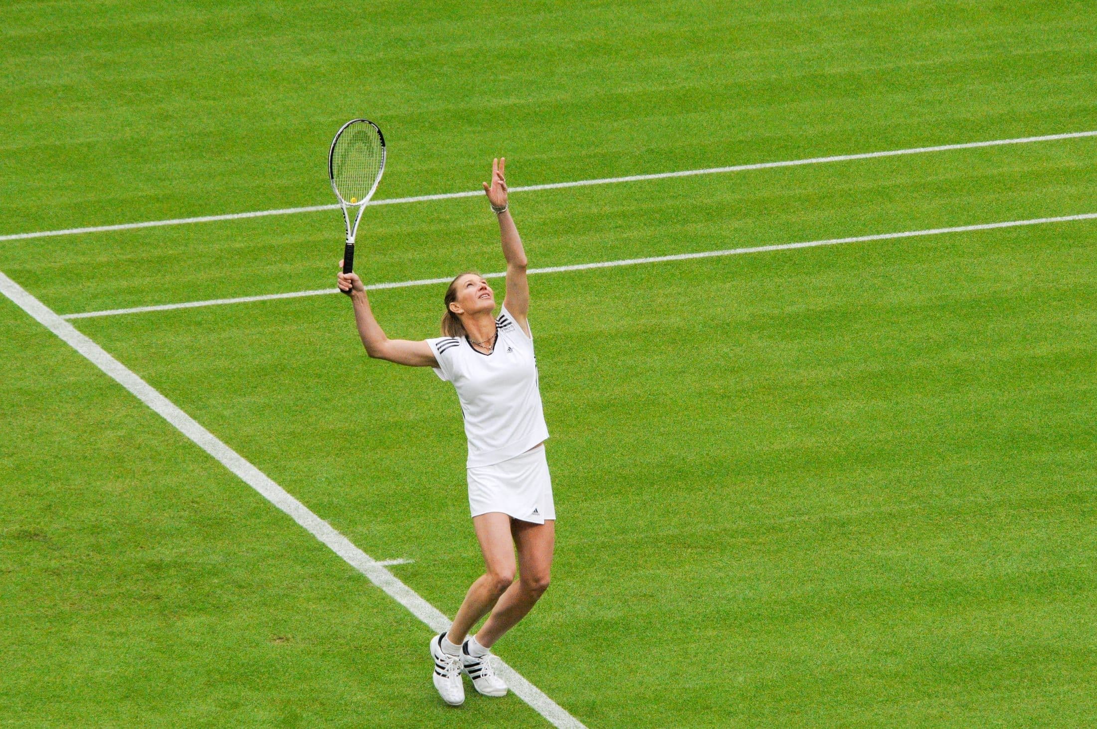 Steffi Graf serving on a grass tennis court